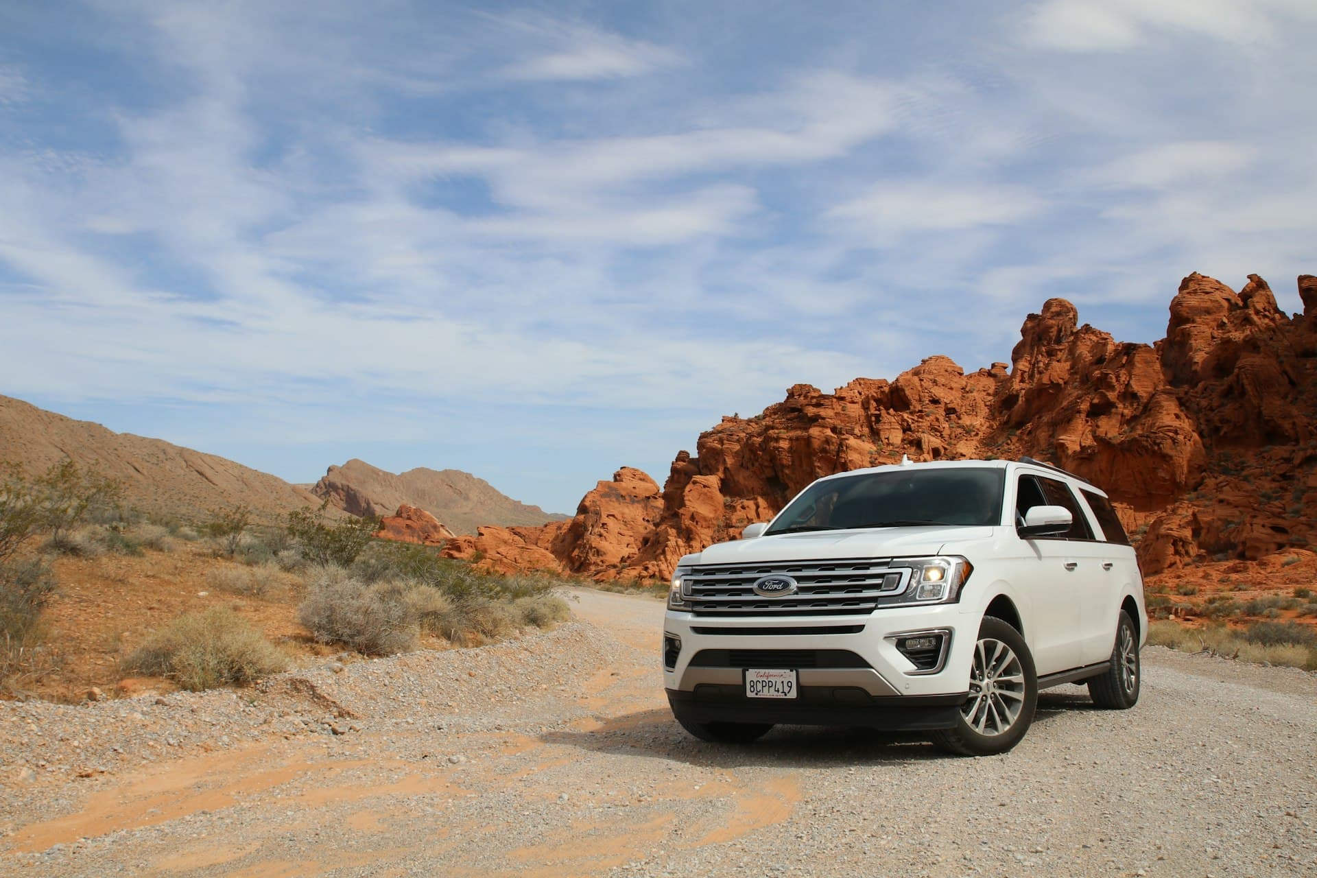 A rental SUV parked on a desert road
