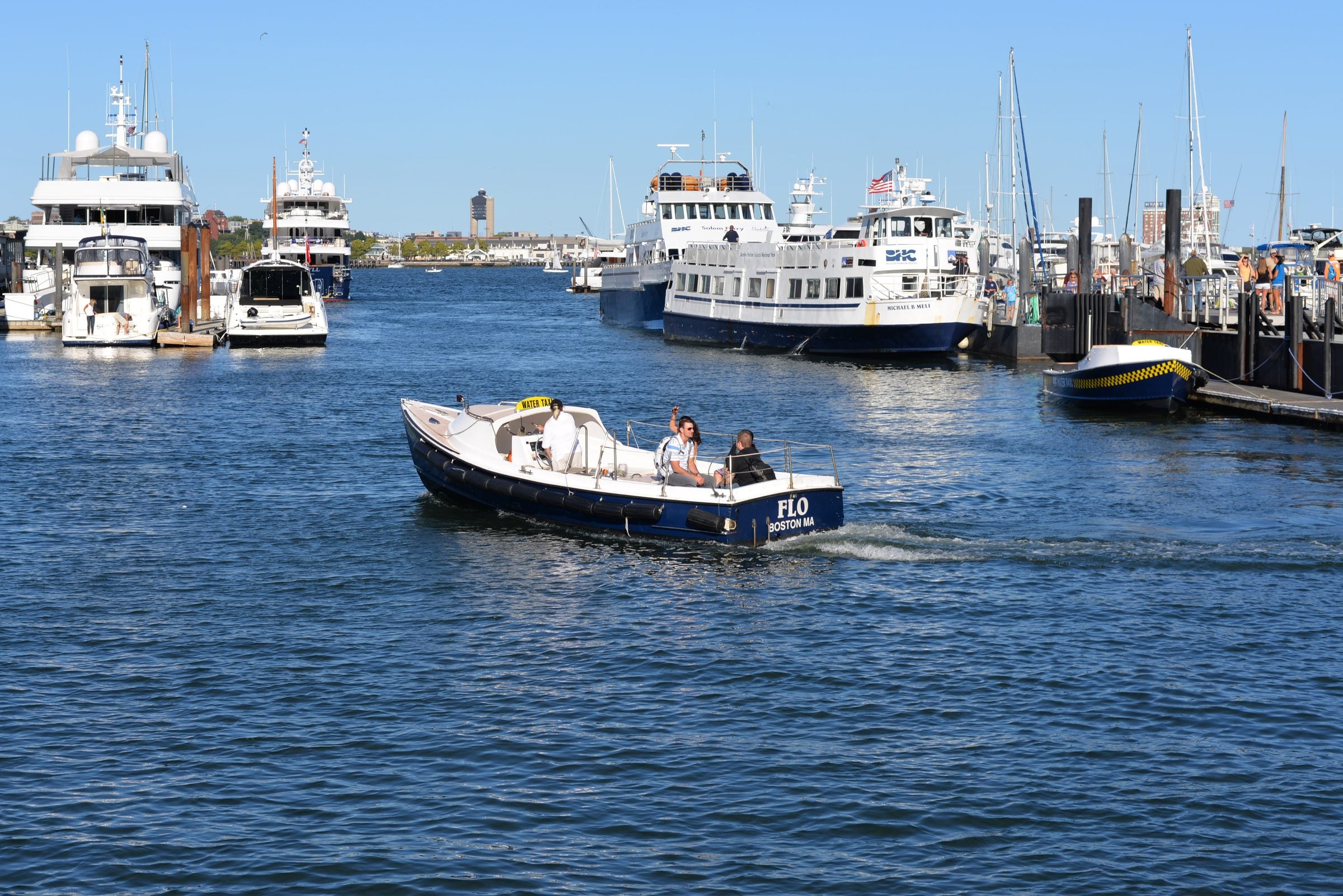 A small passenger water taxi crossing the harbor